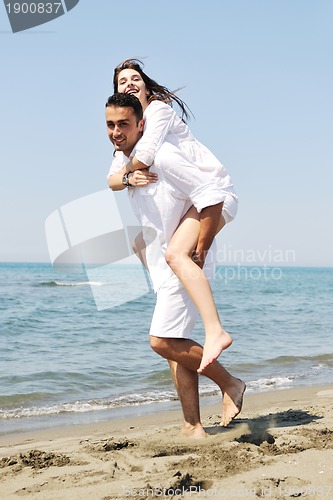 Image of happy young couple have fun on beach