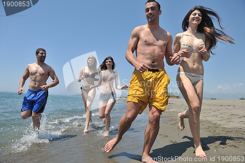 Image of happy people group have fun and running on beach