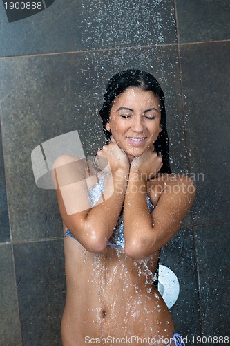 Image of sexy young woman enjoing bath under water shower
