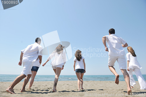Image of happy people group have fun and running on beach