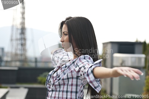 Image of beautiful young lady posing in garden