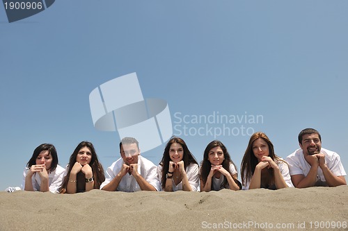 Image of Group of happy young people in have fun at beach