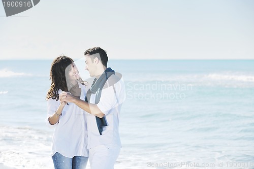 Image of happy young couple have fun at beautiful beach