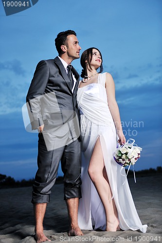 Image of romantic beach wedding at sunset