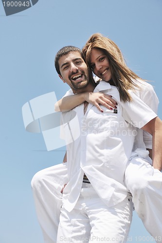 Image of happy young couple have fun on beach