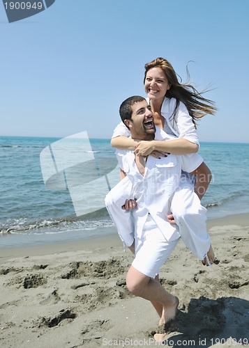 Image of happy young couple have fun on beach