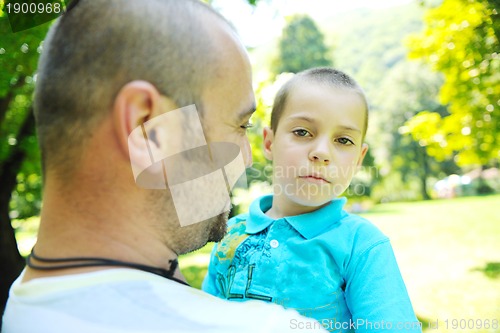 Image of happy father and son have fun at park