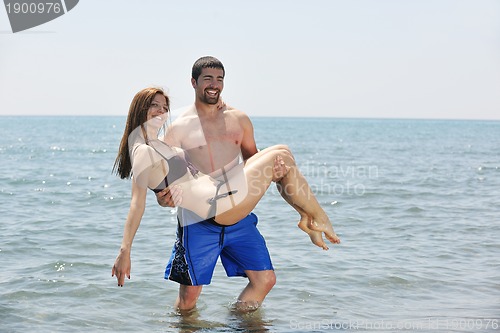 Image of happy young couple have fun on beach