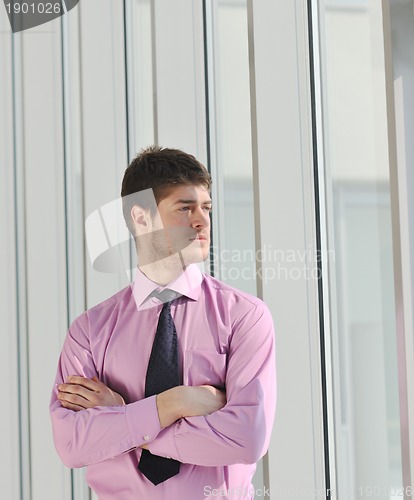 Image of young business man alone in conference room
