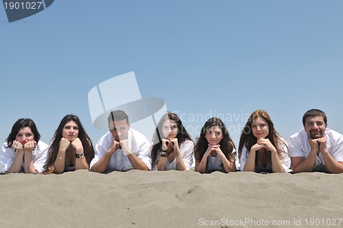 Image of Group of happy young people in have fun at beach