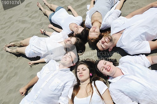 Image of Group of happy young people in have fun at beach