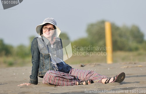 Image of happy young woman on beach