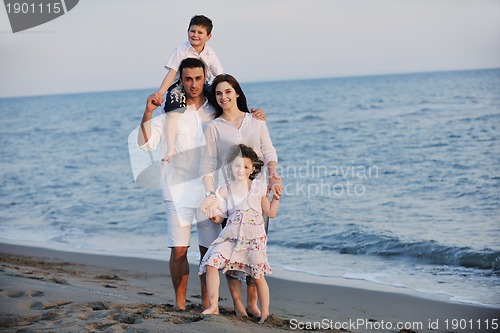 Image of happy young family have fun on beach