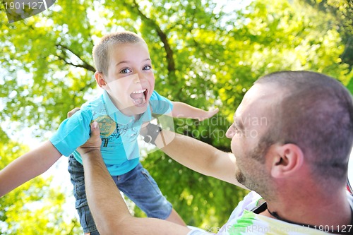 Image of happy father and son have fun at park