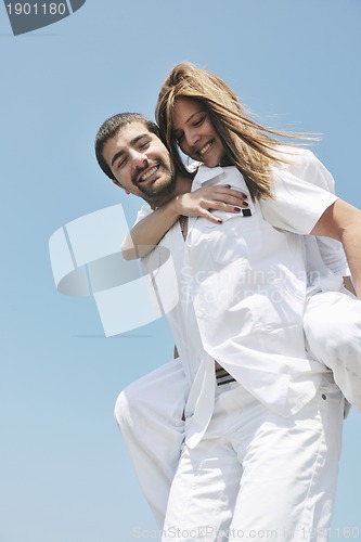 Image of happy young couple have fun on beach