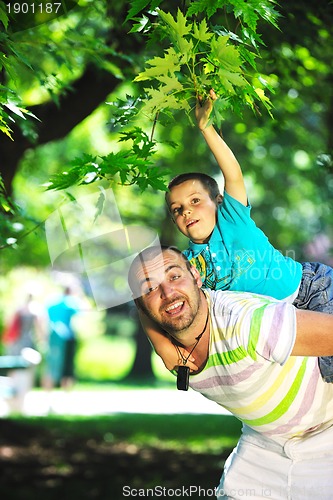 Image of happy father and son have fun at park