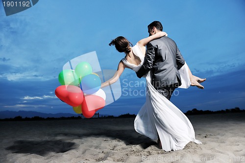 Image of romantic beach wedding at sunset