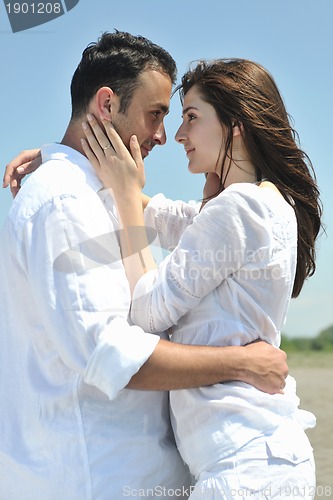 Image of happy young couple have fun on beach