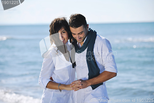 Image of happy young couple have fun at beautiful beach