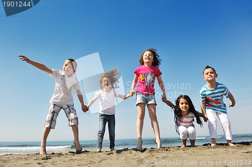 Image of happy child group playing  on beach