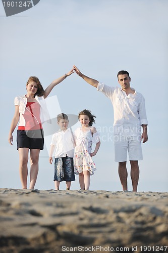 Image of family on beach showing home sign