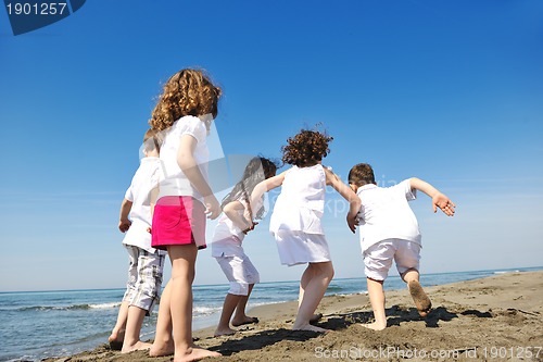 Image of happy child group playing  on beach