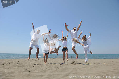 Image of happy people group have fun and running on beach