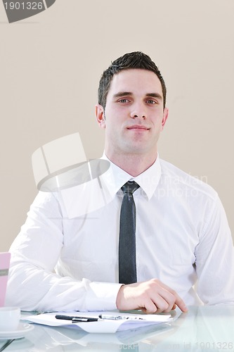 Image of young business man alone in conference room
