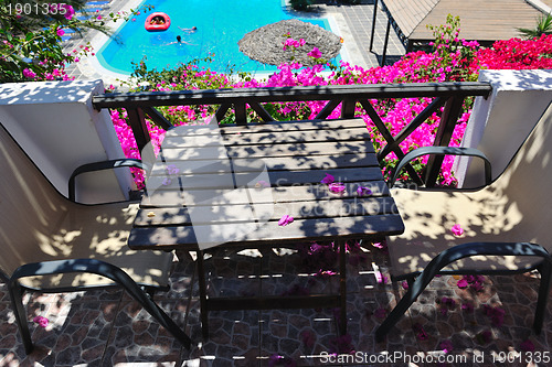 Image of romantic balcony with flowers and pool view