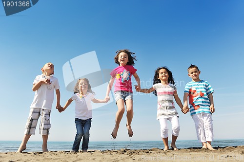 Image of happy child group playing  on beach