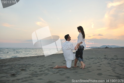 Image of happy young couple have fun on beach