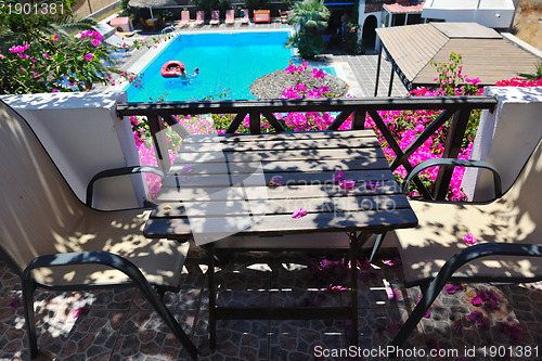 Image of romantic balcony with flowers and pool view