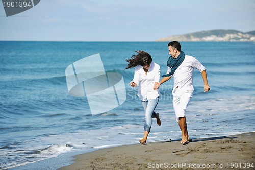 Image of happy young couple have fun at beautiful beach