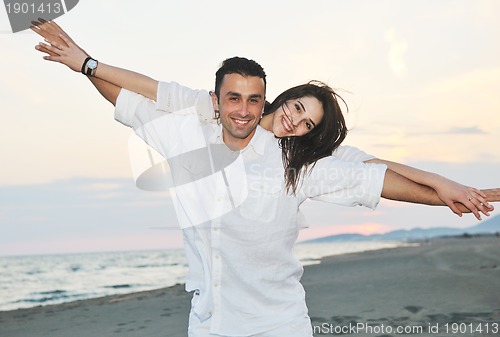 Image of happy young couple have fun on beach