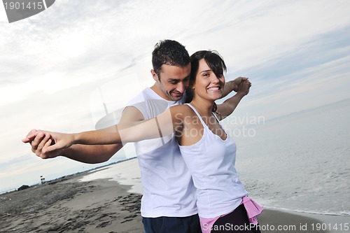Image of happy young couple have fun at beautiful beach