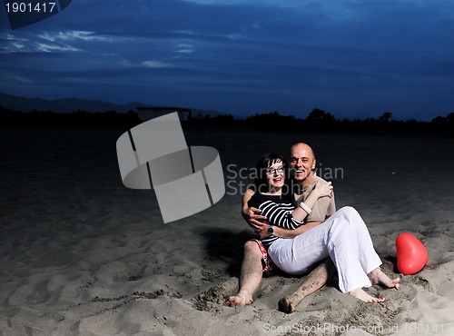 Image of happy young couple have fun on beach