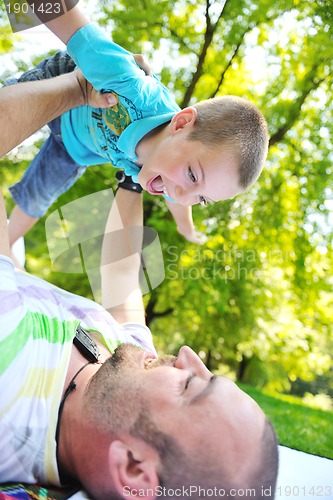 Image of happy father and son have fun at park