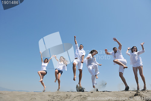 Image of happy people group have fun and running on beach