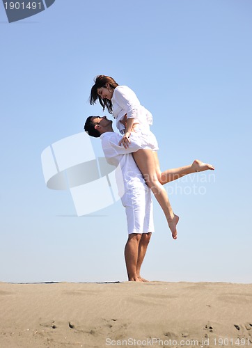 Image of happy young couple have fun on beach