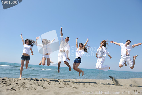 Image of happy people group have fun and running on beach