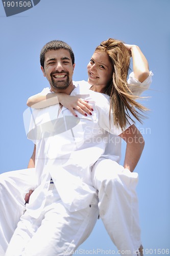 Image of happy young couple have fun on beach