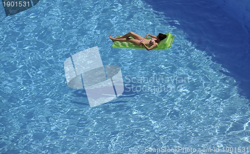 Image of woman relax at swimming pool 