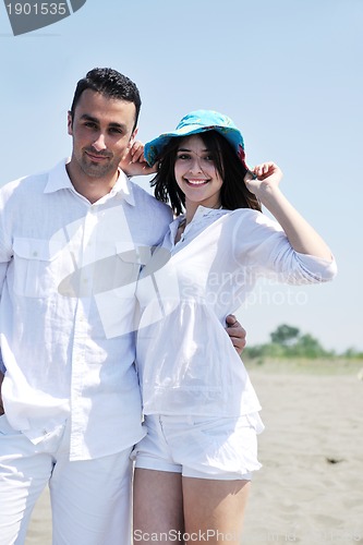 Image of happy young couple have fun on beach