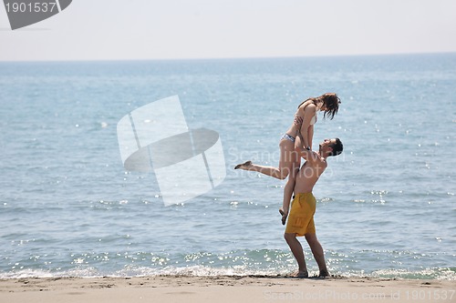 Image of happy young couple have fun on beach