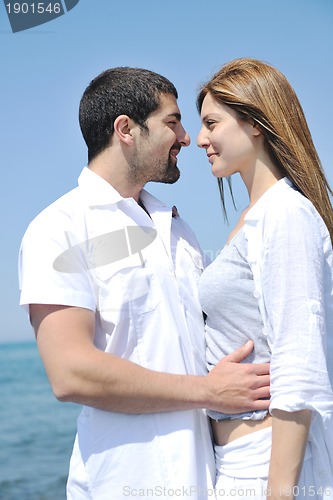 Image of happy young couple have fun on beach