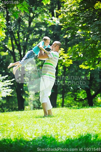 Image of happy father and son have fun at park