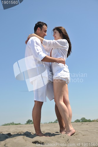 Image of happy young couple have fun on beach