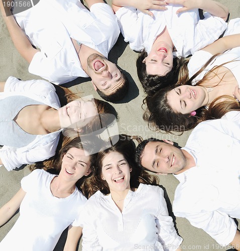 Image of Group of happy young people in have fun at beach