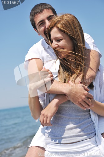 Image of happy young couple have fun on beach