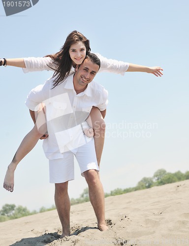 Image of happy young couple have fun on beach